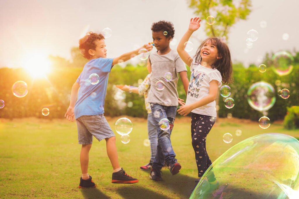 A group of children blowing bubbles & running around. If you suspect your child has anxiety, consider reaching out for a child therapist in Katy, TX. We are here to help your child thrive.