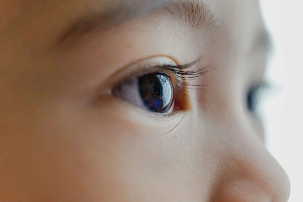 A close up of a child's eye. Representing how EMDR for children can help with anxiety, trauma & more. Call us today to get started with child therapy in Katy, TX. 