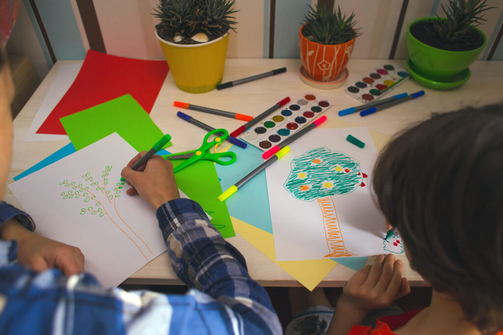 A child & therapist coloring together during therapy. A child therapist in Katy, TX can help your child with anxiety & build resilience. Watch your child thrive today!