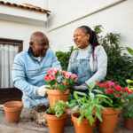 A couple planting bright colored flowers outside. Couples therapy in Katy, TX can help you rekindle the flame. Reach out today to get started!