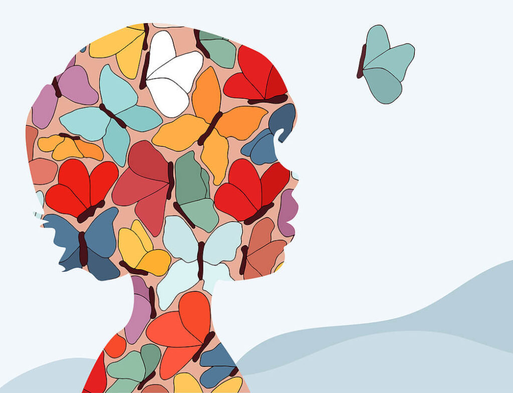 An outline of a child's silhouette filled with colored butterflies. Representing how trauma can affect children differently than adults. Learn more with child therapy in Katy, TX. 