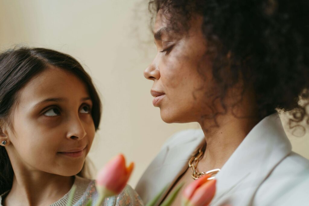 A mother holding her daughter, looking at her with love. If you're family has experienced a tragedy, our Katy therapists can help. Get the support you deserve today.