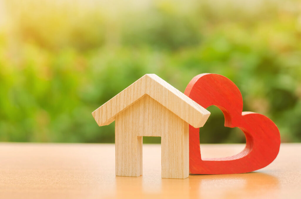 A small wooden house cutout & red heart cutout. Discover affordable child therapy in Katy, TX on our site. We're here to support your whole family.