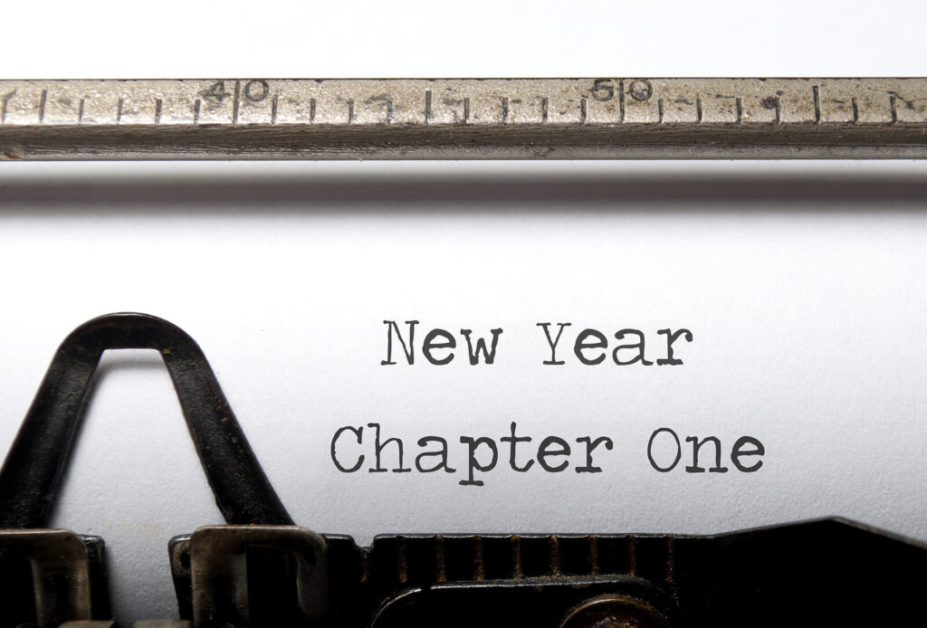 "New Year Chapter One" on a white piece of paper, written by a type writer. Representing how counseling for adults in Katy, TX can help you set realistic goals for the new year. Read more here.